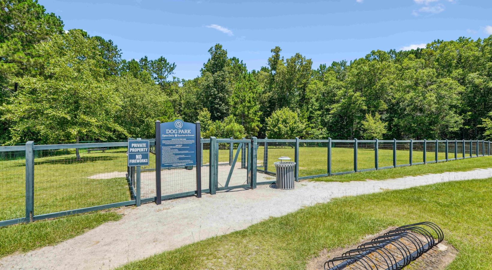 We love our furry friends Fenced off dog park with a sign and trees in the background at Easthaven