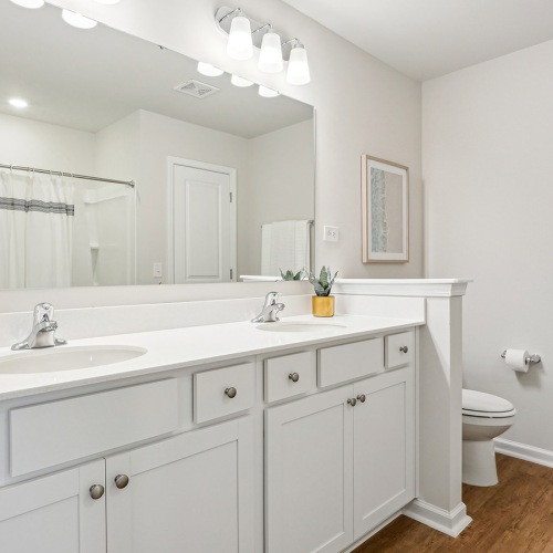 Bathroom options with thoughtful details Spacious townhome bathroom with a sink and large mirror at Easthaven