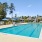 Large community swimming pool with lounge chairs and umbrellas at Easthaven