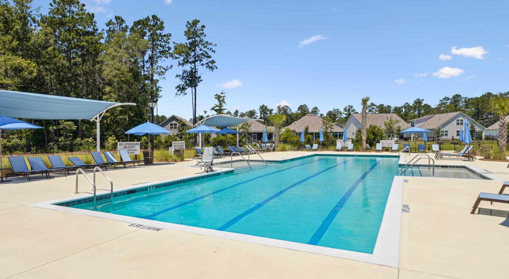 Resort-style swimming pool Large community swimming pool with lounge chairs and umbrellas at Easthaven