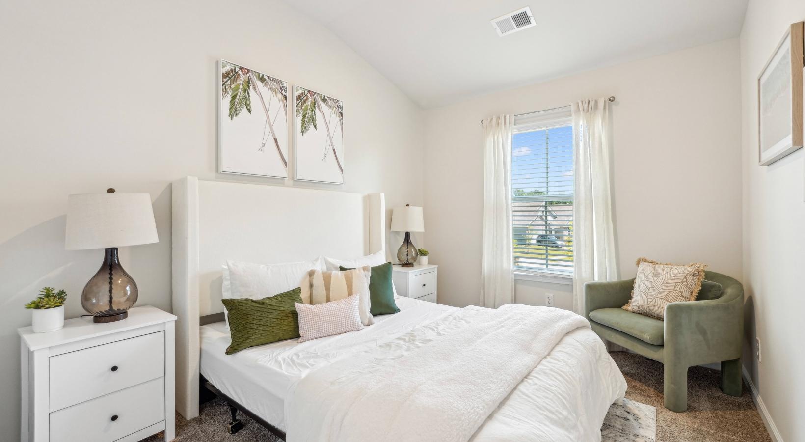 Beautiful bedrooms to fit every need Furnished bedroom with a bed and a chair inside a home at Easthaven