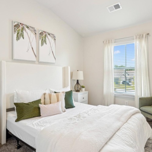 Beautiful bedrooms to fit every need Furnished bedroom with a bed and a chair inside a home at Easthaven